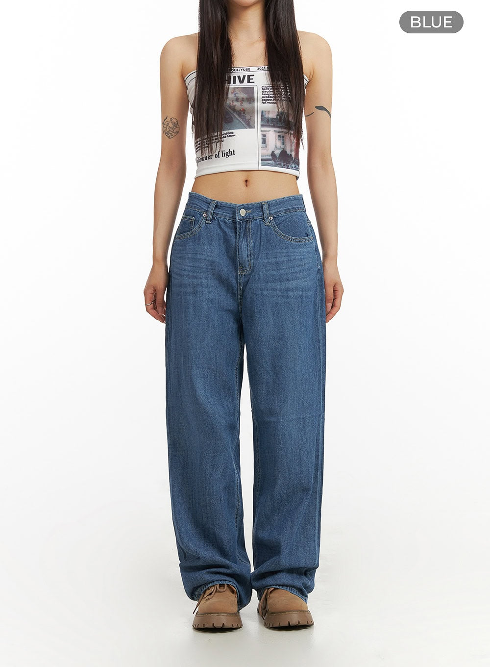 Solid Low Rise Baggy Jeans CY407 in blue, front full-body shot on model, low-rise waist with 5-pocket styling, wide-leg washed denim pooling at hem, paired with graphic tube top.