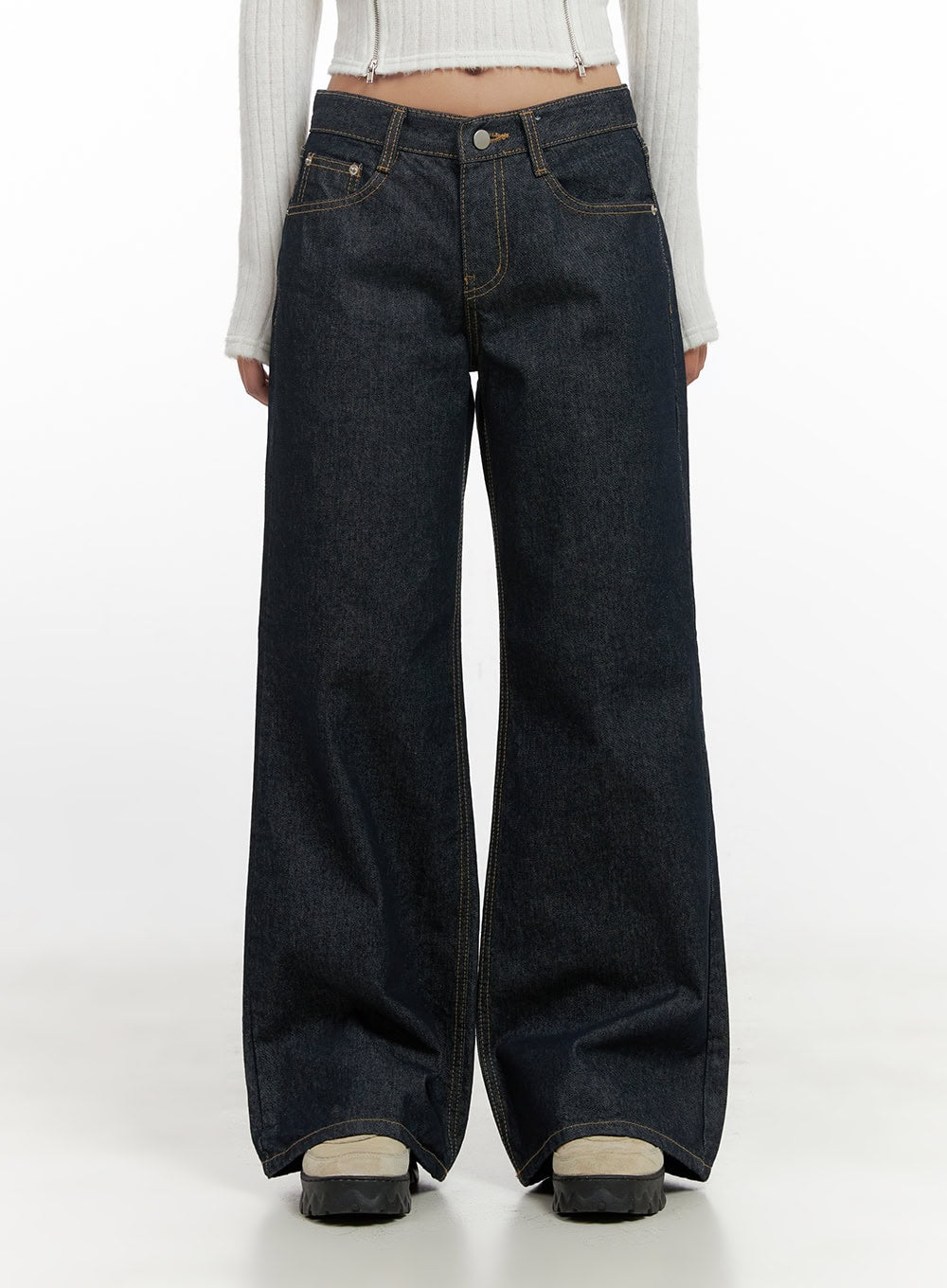 Lisa Cotton Comfort Wide Leg Jeans CN419 in dark blue, front mid-shot on model, low-rise wide-leg cotton denim with five-pocket design and gold contrast stitching, paired with white crop top and chunky boots.