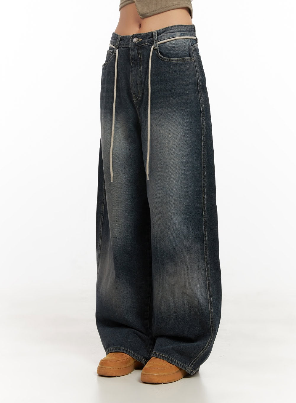 Vivian Washed Cotton Baggy Jeans CD409 in dark blue, angled front-side view on model, cream drawstring hanging from waistband, washed cotton denim with wide voluminous leg.
