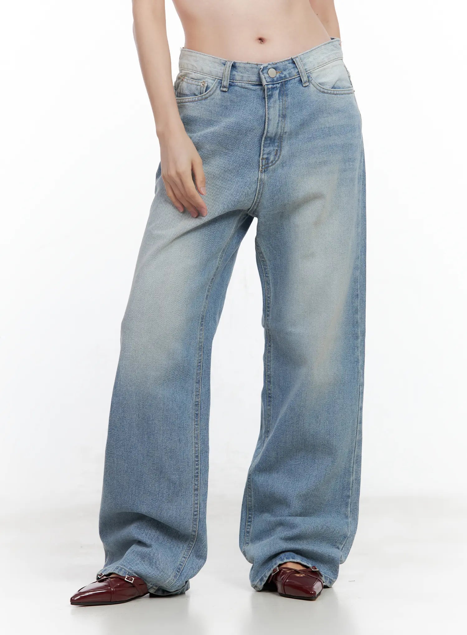 Ina Slouchy Fit Jeans CL502 in blue, front three-quarter close-up on model, washed cotton denim with low-rise fit and roomy wide leg, front pocket detailing, burgundy loafers.