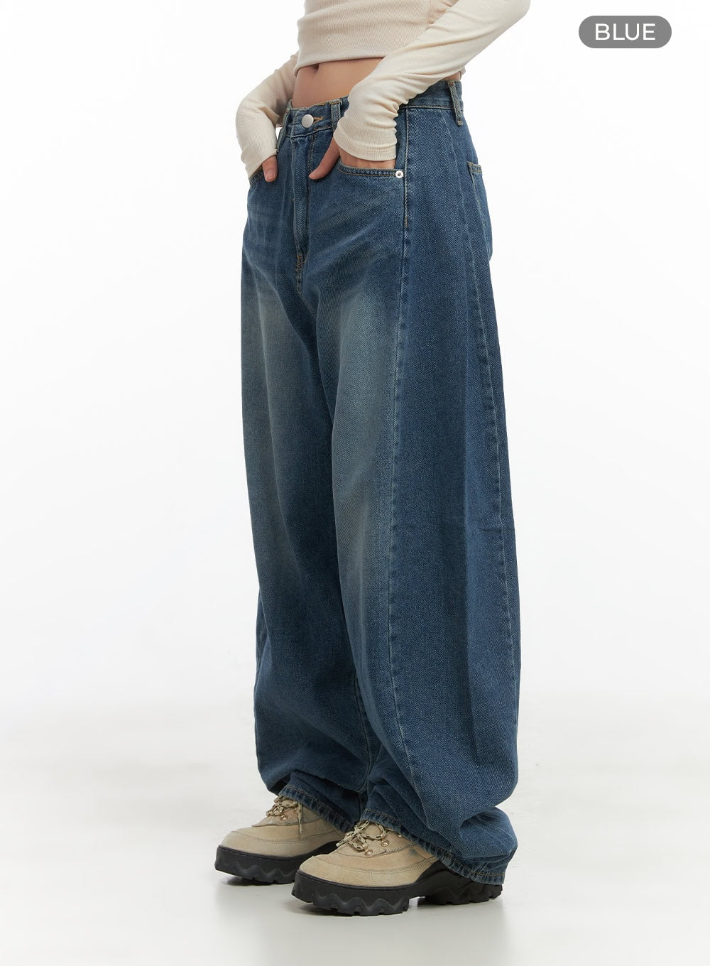 Lacey Washed Denim Baggy Jeans CO404 in blue, side full-length shot on model, color variant label visible, wide-fit washed denim with roomy thigh and stacked hem, chunky sole boots.