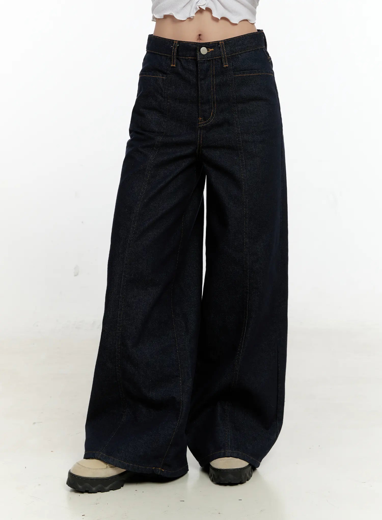 Nala Wide-Leg Bootcut Jeans CN506 in dark blue, front three-quarter view cropped below waist on model, wide-leg volume and contrast gold topstitching highlighted, paired with white crop top.