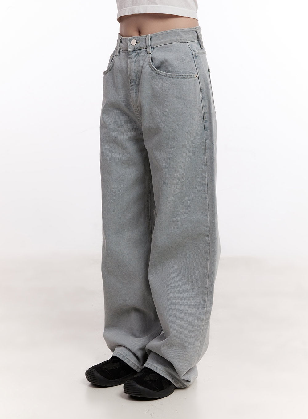 Casey Washed Baggy Wide-Leg Jeans CM526 in light gray, angled front side product shot on model, washed denim with front coin pocket detail, baggy wide leg and stacked hem, paired with black sneakers.