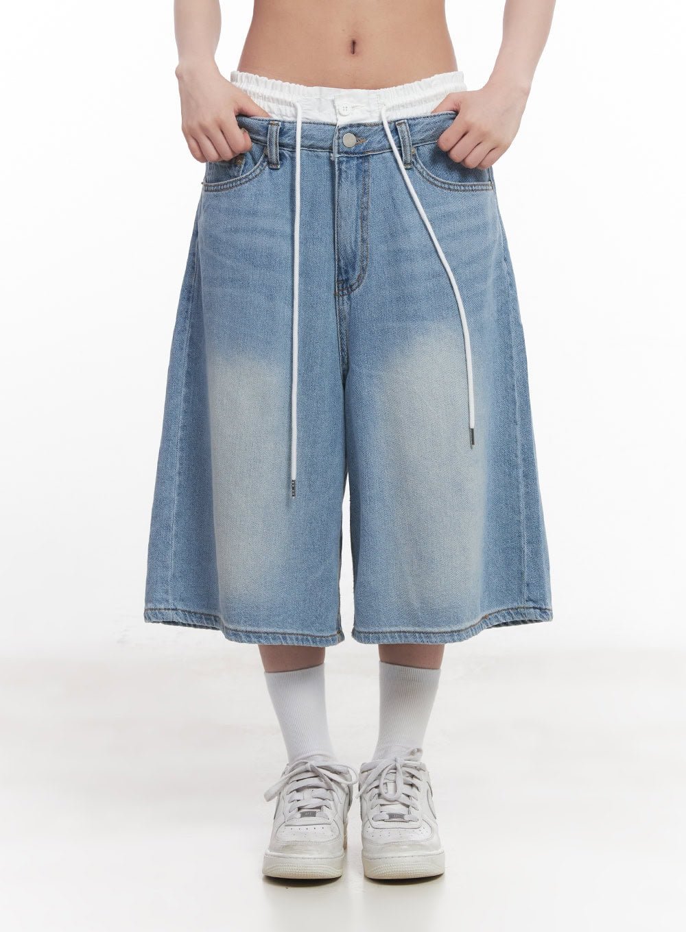 Layered Drawstring Baggy Jorts CY527 in light blue, front close-up on model holding waistband, highlighting white ruched layered waistband, drawstring detail, and washed cotton denim on wide baggy silhouette.