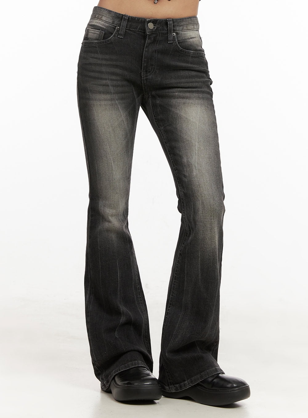 Georgina Low-Rise Flared Jeans CJ507 in black, front 3/4 view cropped at waist on model, five-pocket low-rise design, washed black denim with grey fading, bootcut flare silhouette, paired with black loafers.