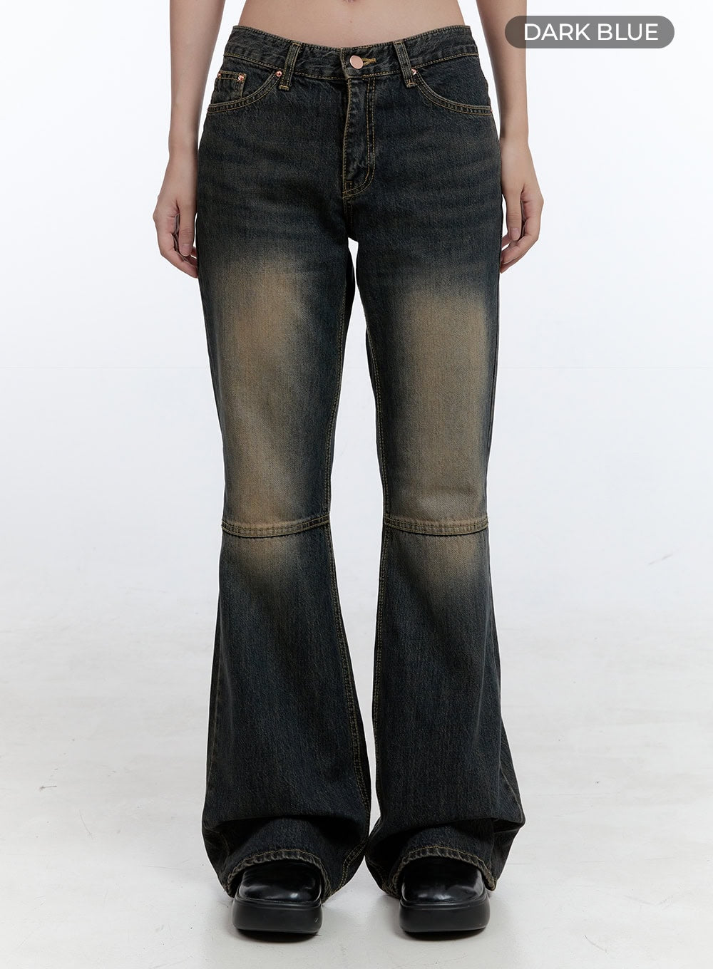 Kira Stitched Detail Bootcut Jeans CG414 in dark blue, front full-length product-focused shot on model, low-waist washed cotton denim, amber fade at thigh and knee, horizontal stitch seam above bootcut flare.
