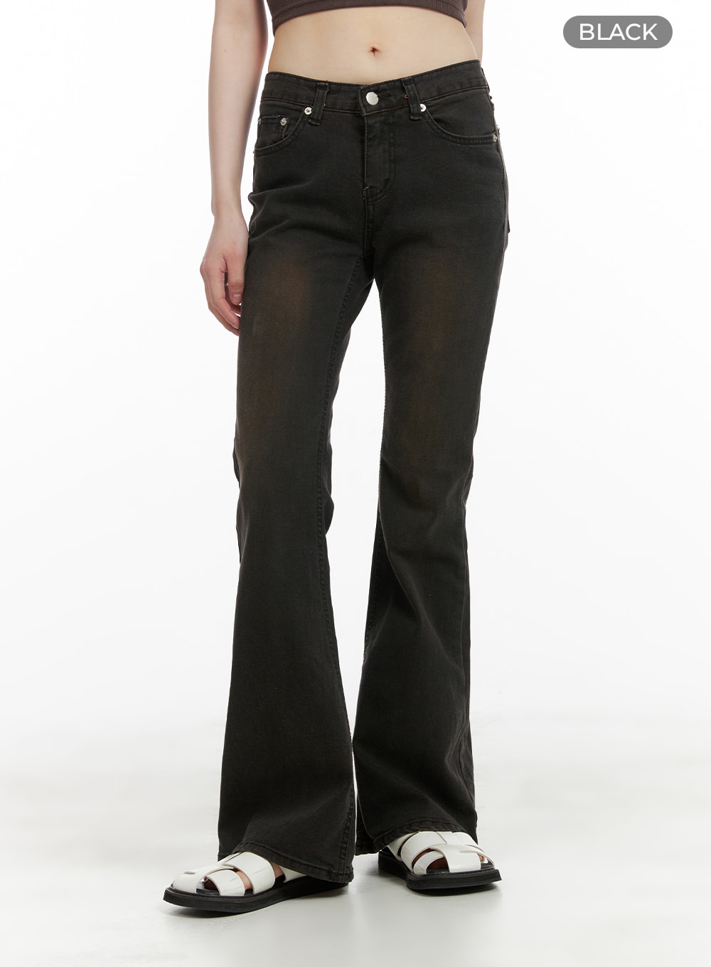 Vintage Washed Bootcut Jeans CA412 in black, front mid-shot on model, low-rise waistband, five-pocket style, warm-toned vintage wash on denim, white sandals.