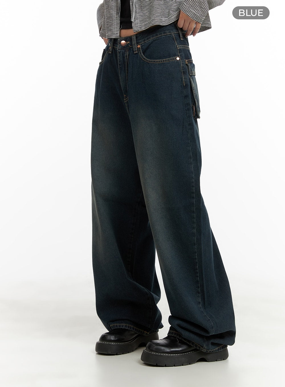 Washed Denim Baggy Jeans CA415 in blue, side view on model, wide-fit baggy silhouette with washed denim, side utility pocket detail, contrast stitching, floor-length hem pooling over chunky loafers.