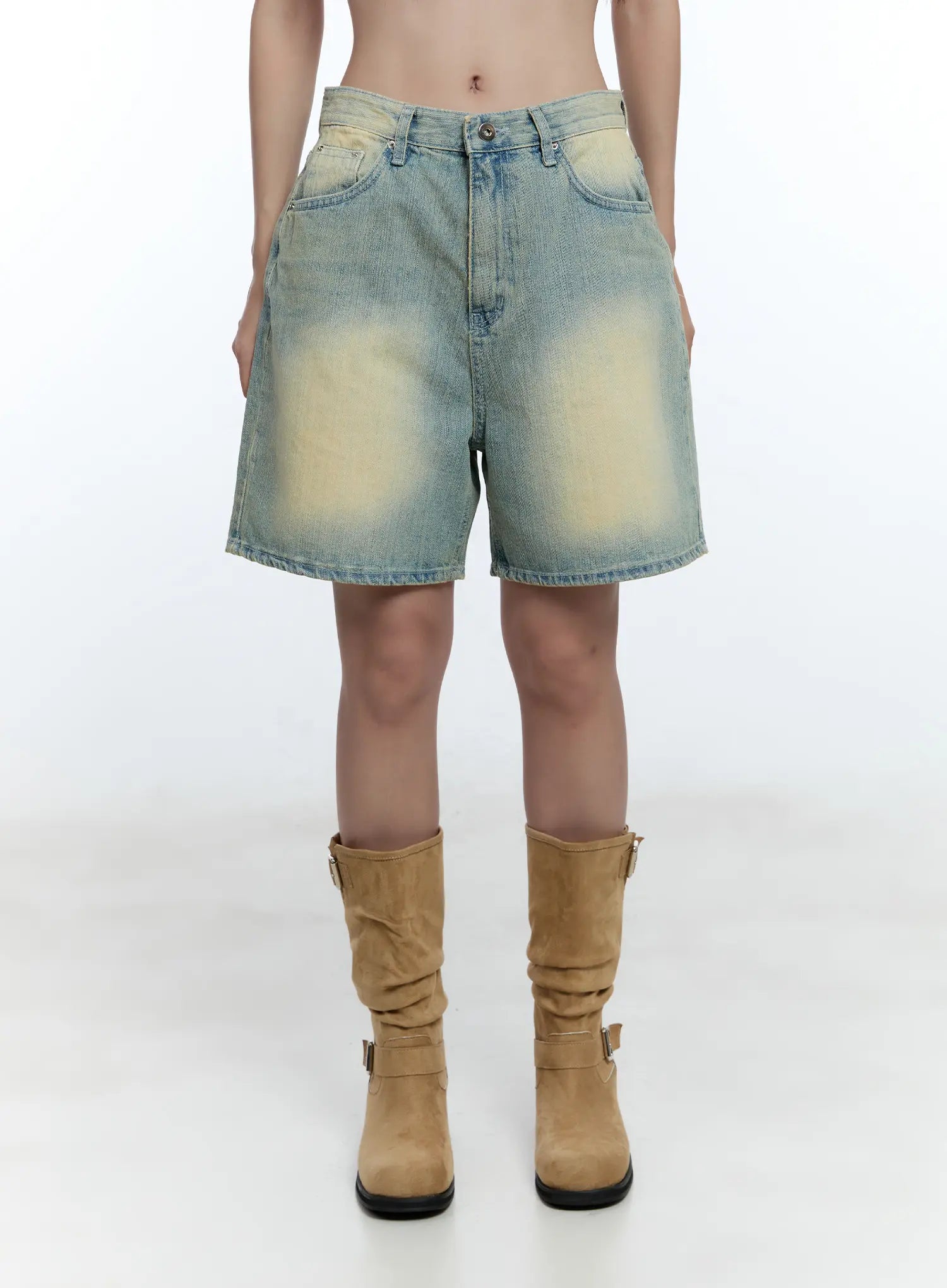 Vintage Wash Jorts CU527 in light blue, straight-on front close-up on model, wide-fit denim with bold yellow vintage wash fade, 5-pocket design, tan suede boots.