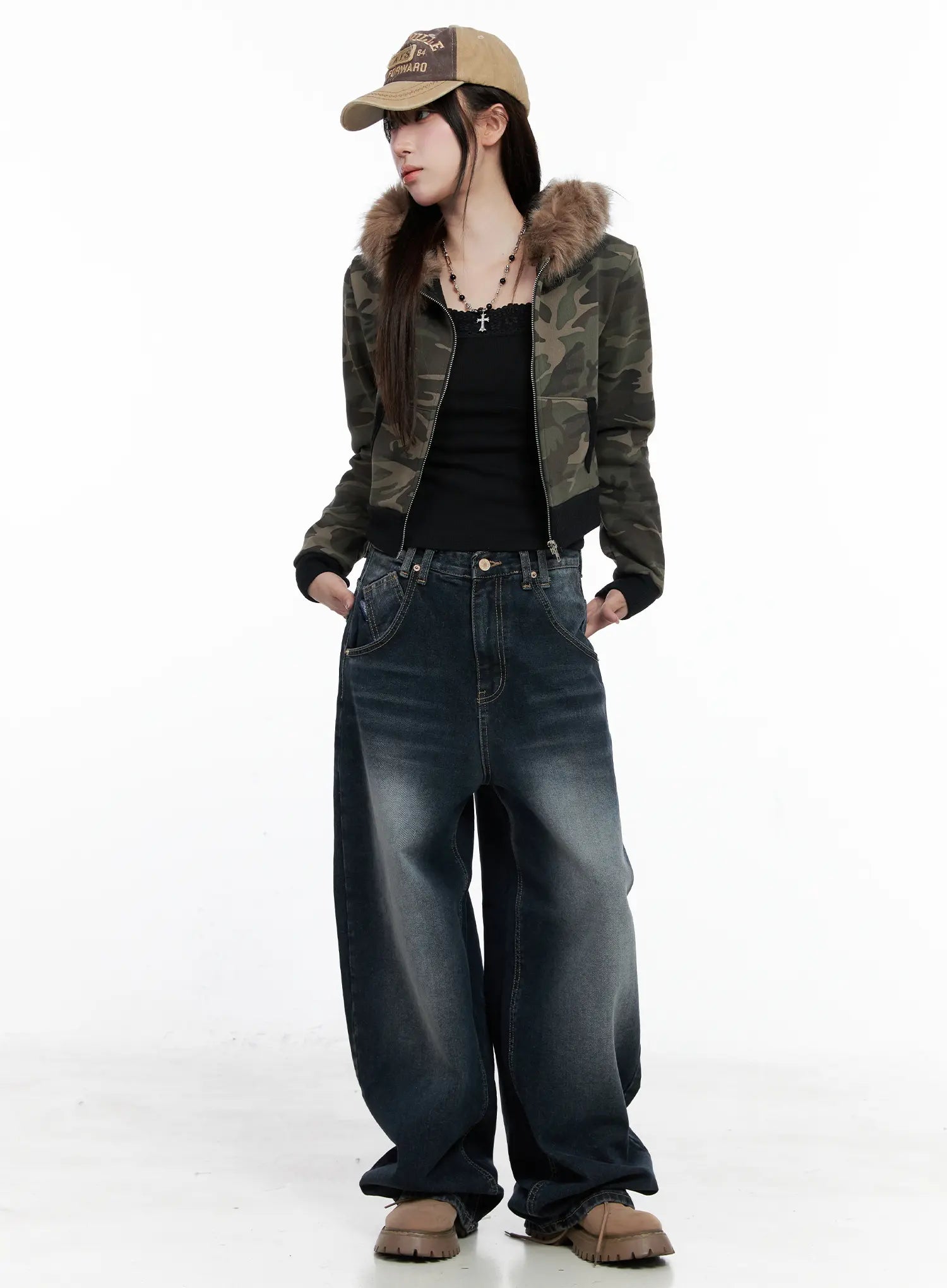 Isla Washed Baggy Jeans CO521 in dark blue, full-body front shot on model styled with camo fur-hood jacket, black tank, baseball cap, and chunky boots in street acubi look.