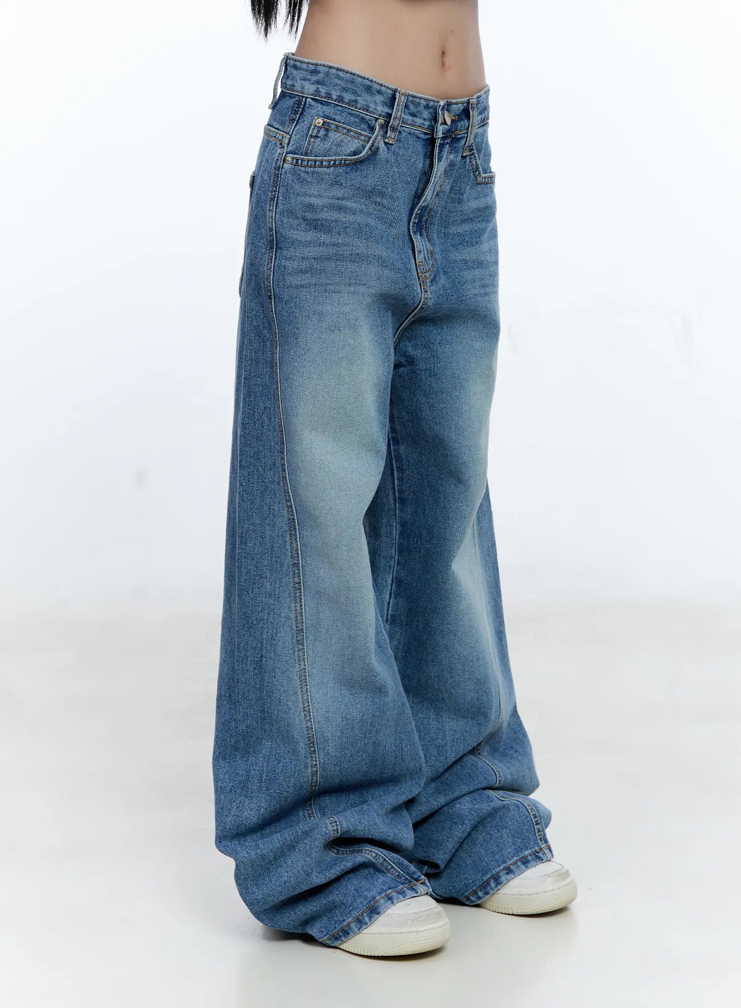 Ana Wide-Leg Denim Jeans CG507 in blue, side close-up on model from waist to hem, washed cotton denim highlighting waistband, front pocket, center seam, and pooled wide leg.