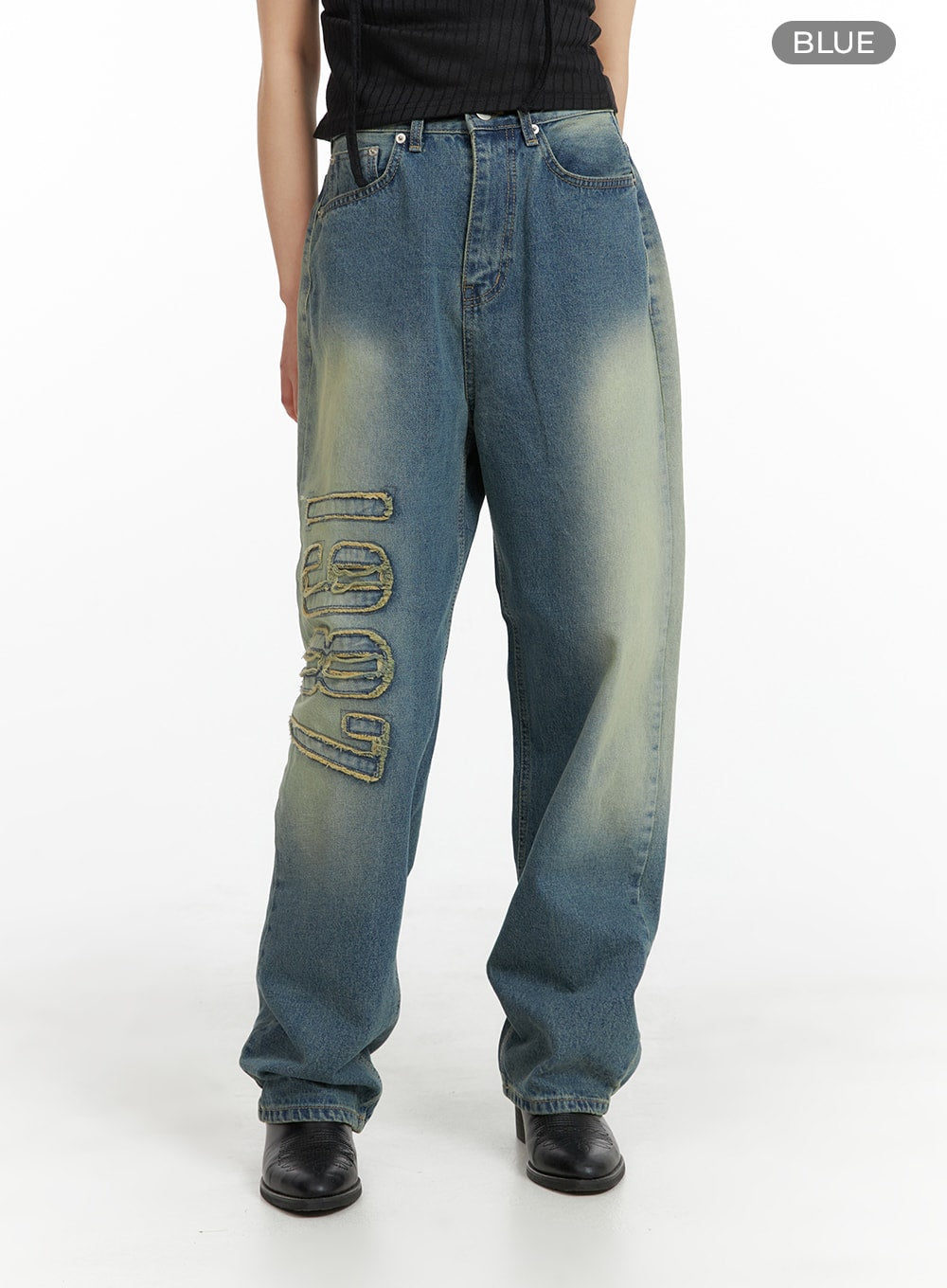 Distressed Baggy Straight Jeans CM413 in blue, front full-length product shot on model, washed cotton denim wide-fit with '1987' raised appliqué on left thigh and yellow-tinted fading.
