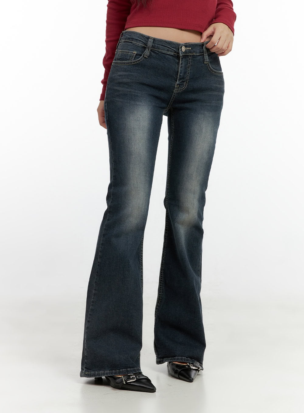 Ingrid Low-Rise Washed Flared Hip Pad Denim Jeans CN404 in dark blue, front angled close-up on waist and thigh, low-rise button closure, washed fading detail, slim fit into wide flared hem.