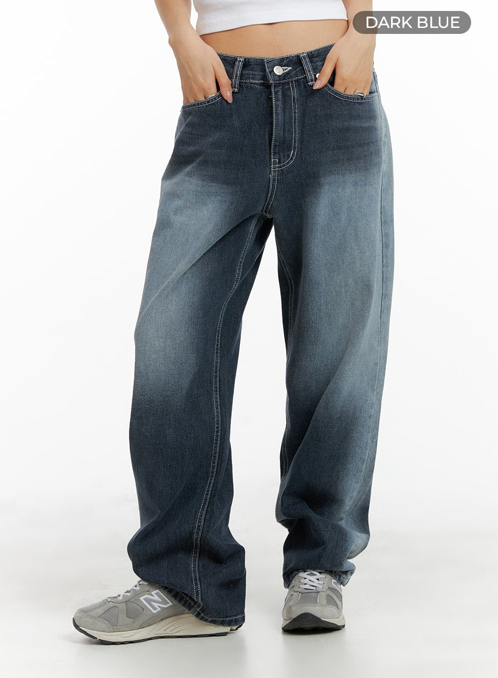 Recycled Wide Baggy Jeans (Unisex) CM425 in dark blue, front three-quarter view on model, color swatch label visible, wide baggy fit washed denim with white topstitching and silver hardware, styled with grey sneakers.