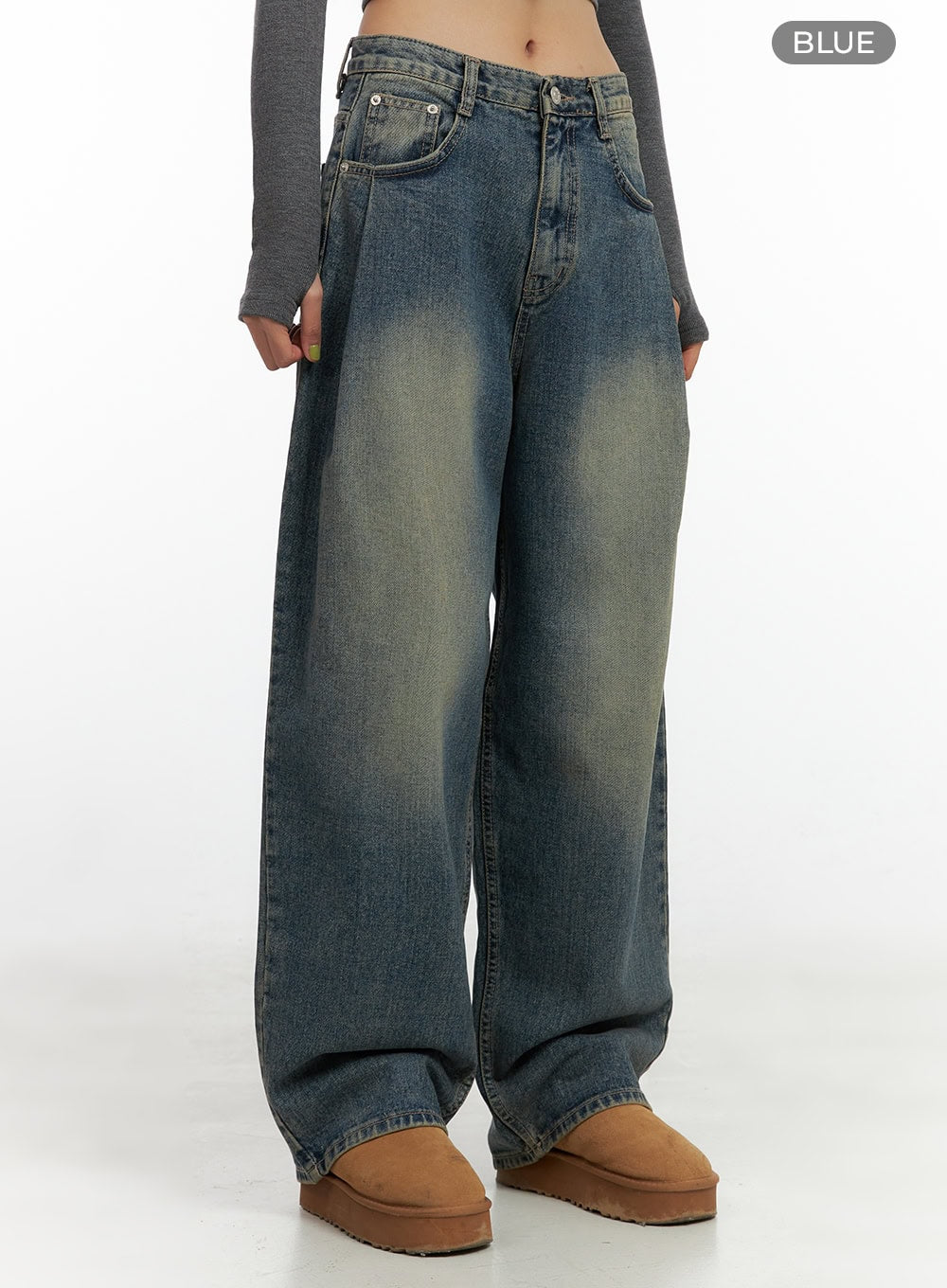 Peyton Pin-Tuck Washed Baggy Jeans CO424 in blue, front mid-body shot on model, washed denim with yellow-tinted fading and pintuck pleats at waist, ultra-wide baggy leg silhouette.