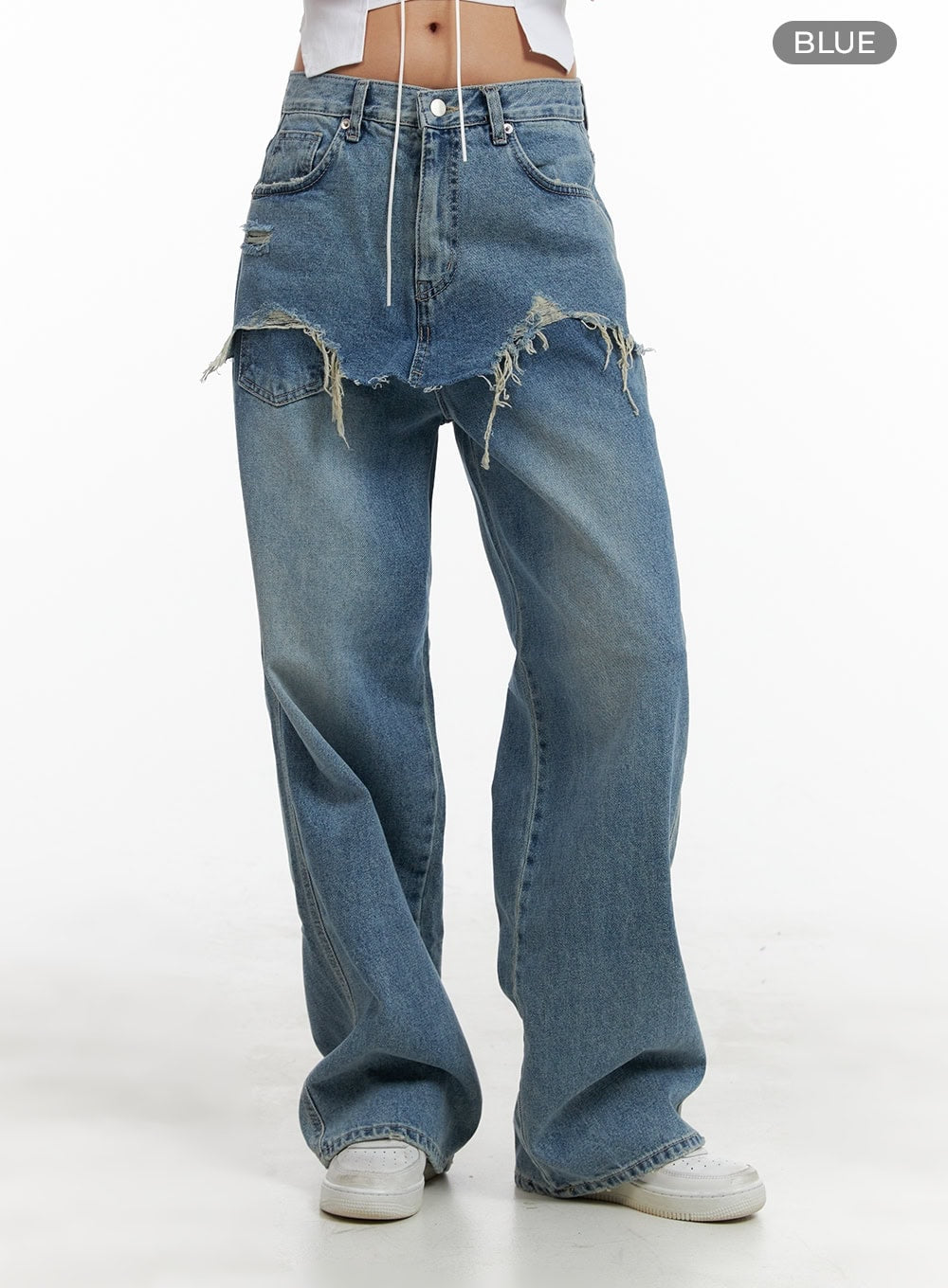 Layered Wide Leg Jeans CA430 in Blue, straight-on front product-style shot on model, full leg visible with destroyed frayed layered skirt overlay, wide-fit washed denim, white sneakers, color label shown.