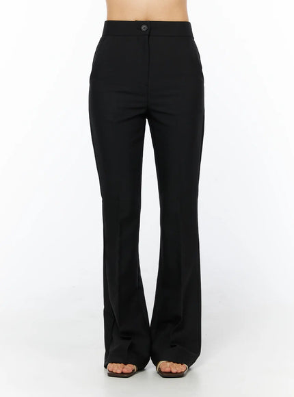 Basic High-Waist Stretch Flared Slacks CU522 in black, front close-up on model, single button closure at waistband, clean flat front, flared trouser leg in smooth stretch fabric.