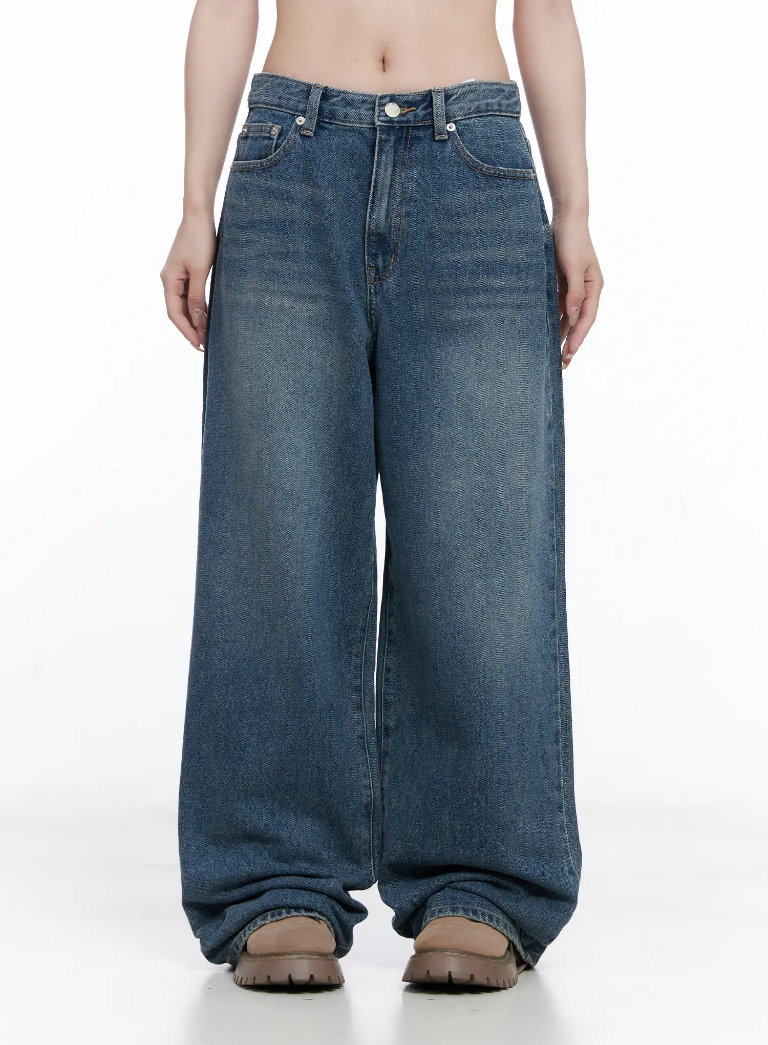 Amalia Wide Leg Vintage Washed Jeans CG529 in blue, front full-length view on model with arms at sides, baggy wide-leg silhouette, vintage sun-faded wash, long inseam pooling over boots.