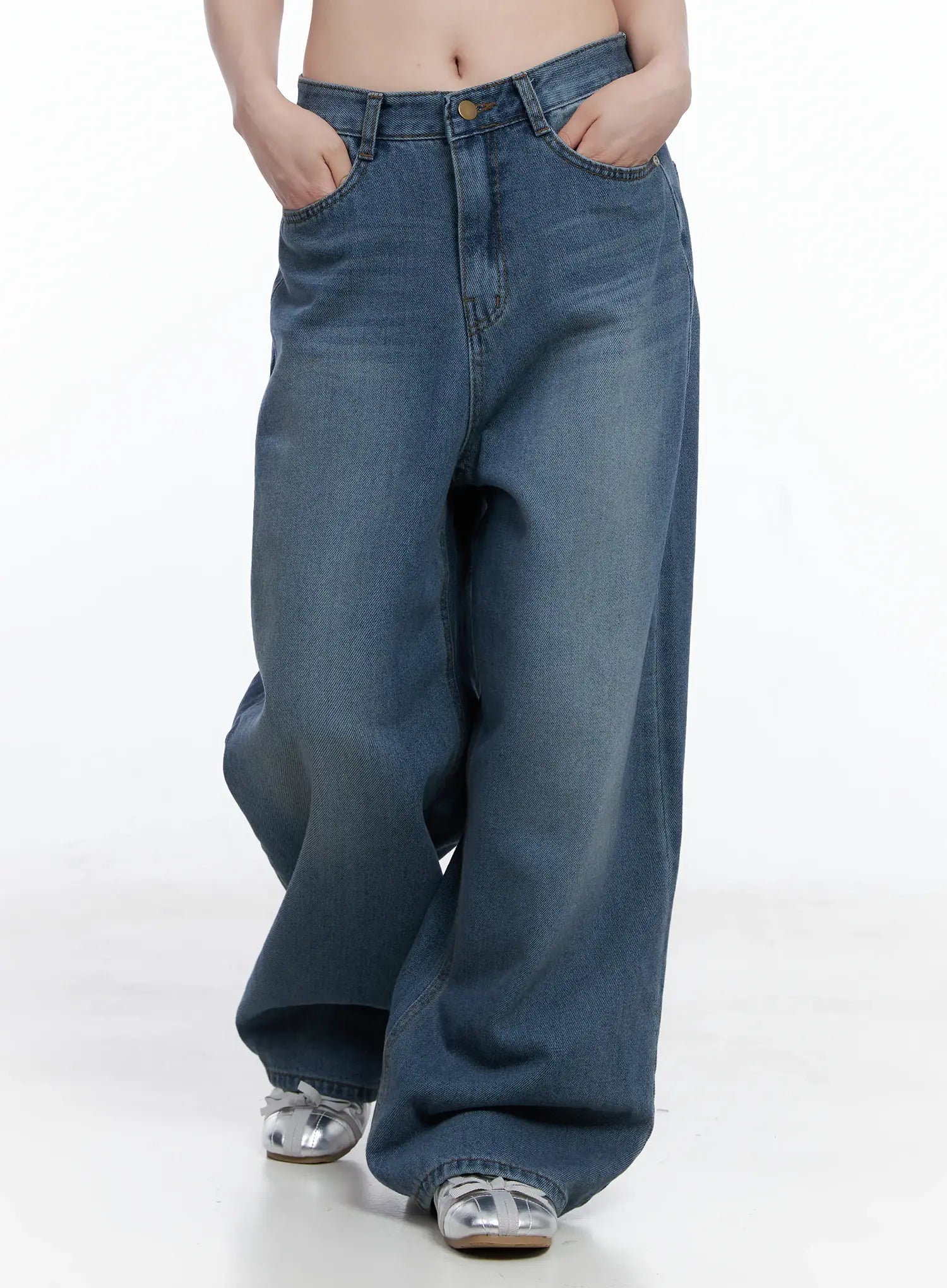 Margot Low-Rise Washed Wide-Leg Jeans CS501 in dark blue, front three-quarter shot on model, hands in pockets, wide-leg drape and low-rise fit clearly shown, silver sandals.