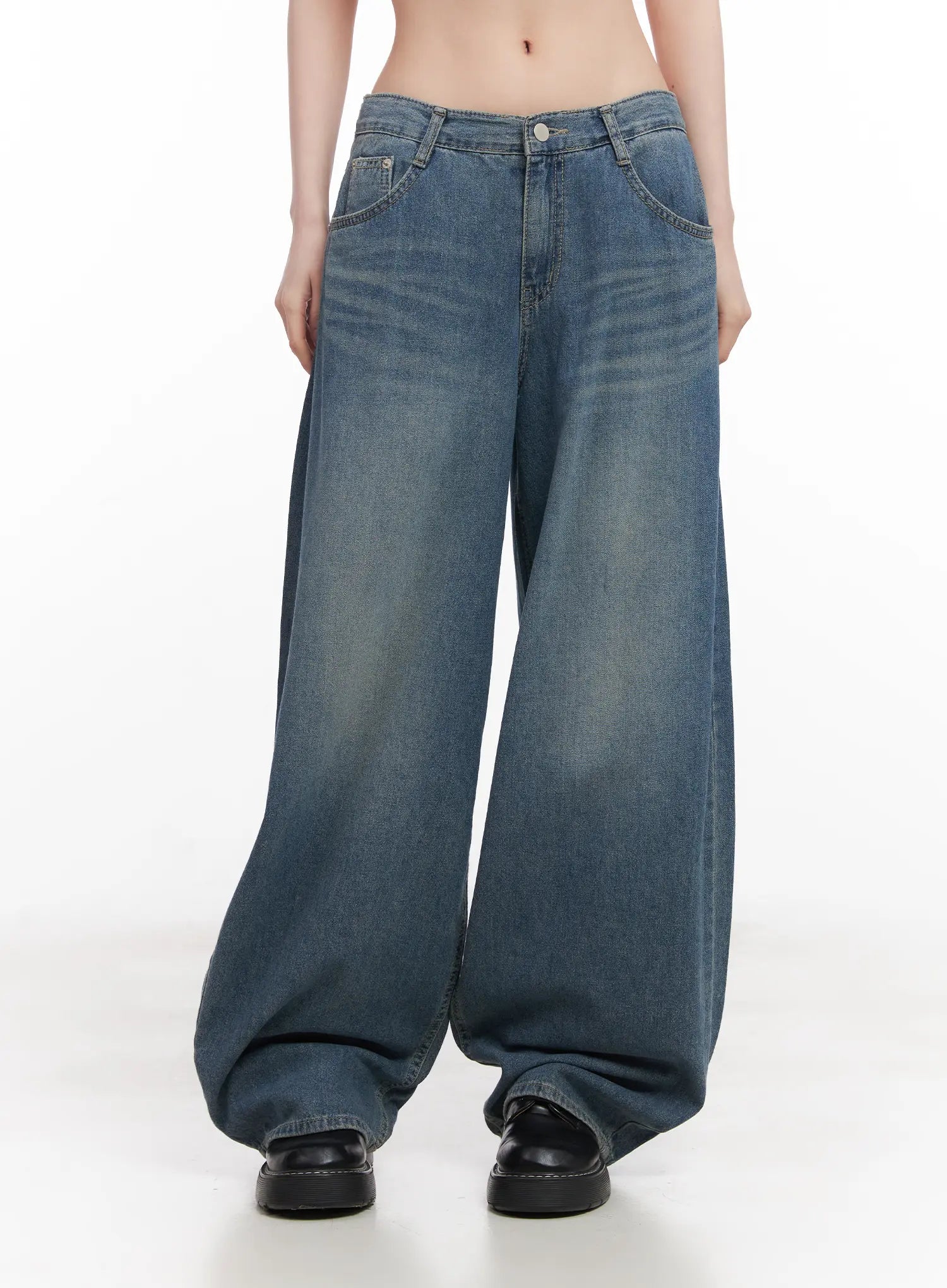 Chaewon Washed Wide-Leg Jeans CU511 in blue, front mid-shot on model, low-rise waistband with button closure, washed denim fading detail, extremely wide-leg cotton denim.