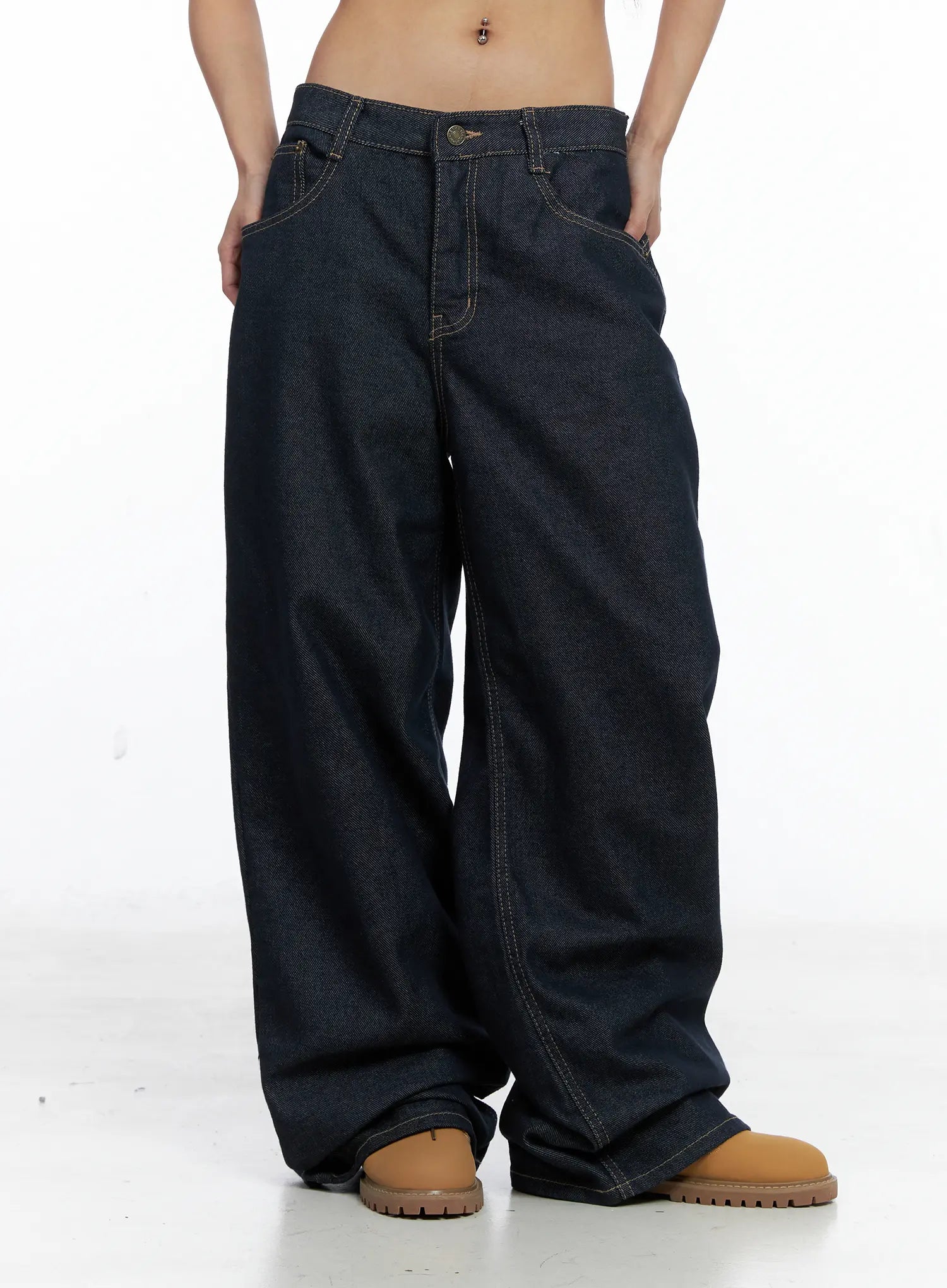 Giada Raw Indigo Wide-Leg Jeans CS505 in dark blue, front cropped shot on model, low-rise fit with button fly, deep front pockets, voluminous wide-leg drape on raw indigo cotton.