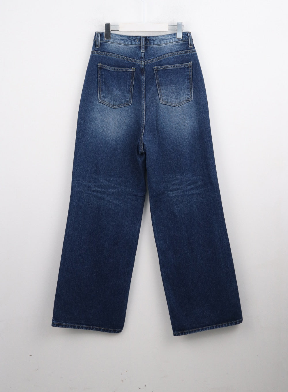 Washed Blue Wide Jeans CN301 in blue, flat back hanger shot, showing dual back patch pockets, washed indigo denim with fade detail, wide-leg cut, and clean hem finish.