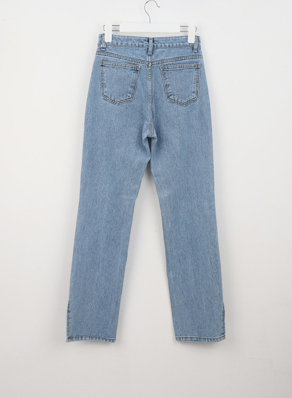 Slit Detail Jeans OU314 in blue, flat back hanger shot, showing dual back pockets, clean seams, and side slit detail at hem on straight-fit cotton denim.