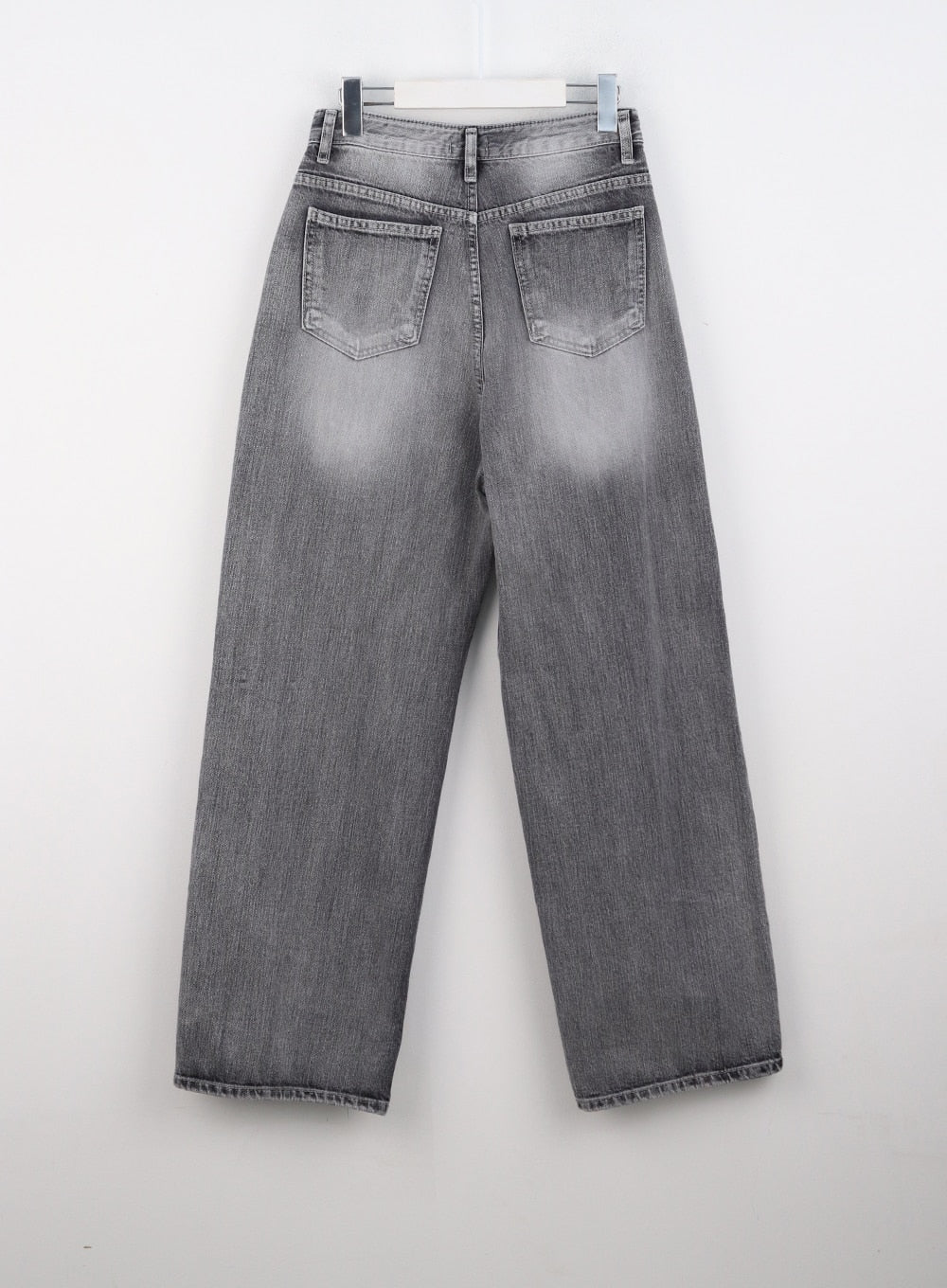 Grey Washed Wide Leg Jeans CO323 in Gray, flat back product shot on hanger, showing dual back patch pockets, faded wash on wide-leg cotton denim, and raw-edge hem detail.
