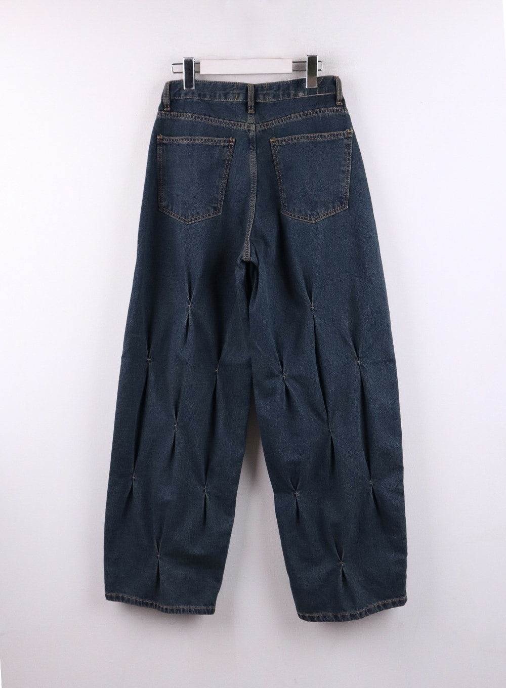 Quilted Wide Leg Denim CF406 in dark blue, flat back product shot on hanger, rear pockets and quilted pintuck stitch detail visible across both wide-leg panels.