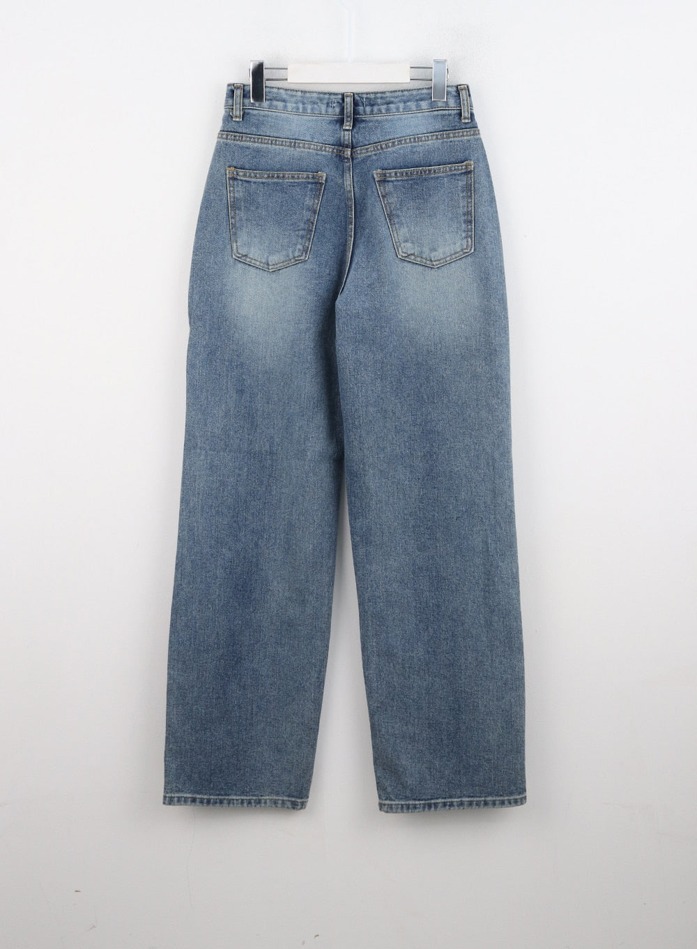 Straight Fit Jeans CN324 in blue, flat back product shot on hanger, washed denim showing two back patch pockets, wide-leg cut, and even wash with light fading.