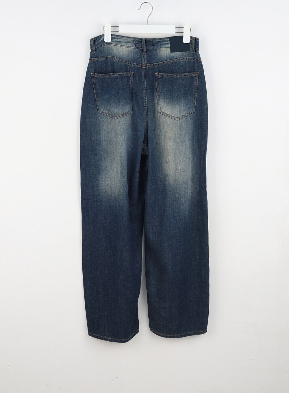 Baggy Low Rise Jeans CA326 in dark blue, flat back hanger shot, rear patch pockets with contrast stitching, wide-leg denim with vintage wash and brand label at waistband.