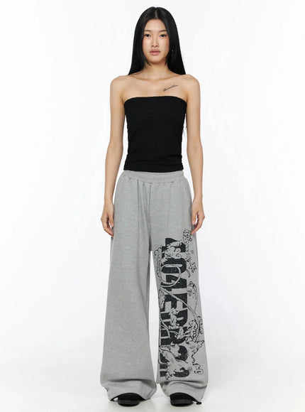 404 Error Graphic Sweatpants IL516 Gray front shot on model standing straight wearing black strapless top showing full-length wide-leg silhouette with side graphic