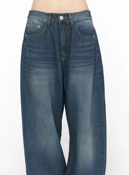 Ace Washed Wide Leg Jeans CL522 Dark blue close-up front detail on model, highlighting low-rise waistband, button closure, coin pocket, yellow contrast stitching, and faded wash texture