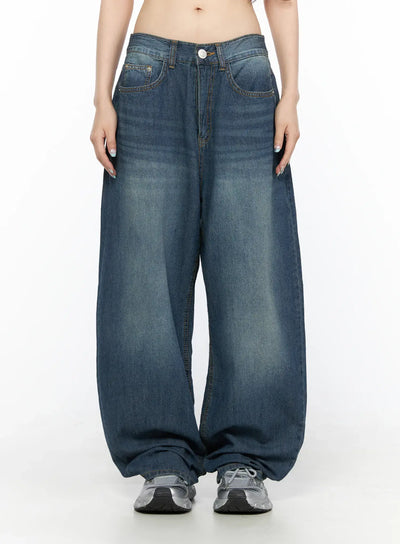 LEWKIN Ace Washed Wide Leg Jeans CL522 Dark blue front view on model size S, low-rise waistband with button closure, faded wash balloon silhouette, worn with silver sneakers