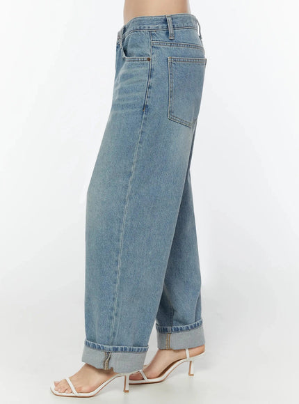Adeya Cuffed Straight Jeans IU524 Blue side shot on model from waist to hem showing side seam, back pocket, wide-leg silhouette, and cuffed hem with white heeled sandals