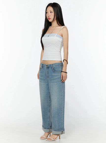 Adeya Cuffed Straight Jeans IU524 Blue three-quarter side shot on model wearing white cami top, showing wide-leg profile and cuffed hem with white heeled sandals