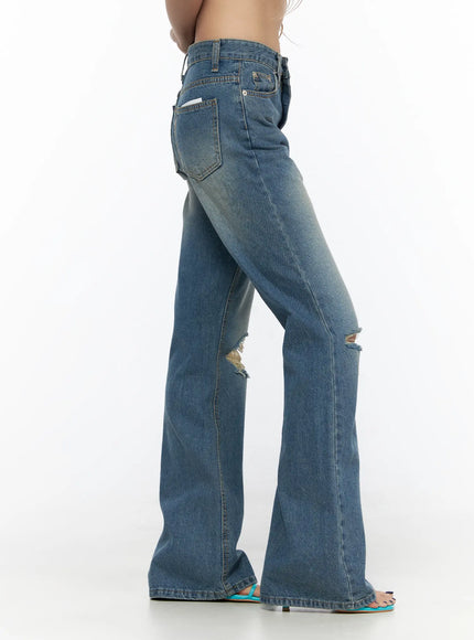 Ahmad Distressed Flared Jeans CL528 Blue side shot on model showing back pocket flare silhouette knee distressing faded denim wash and teal sandals
