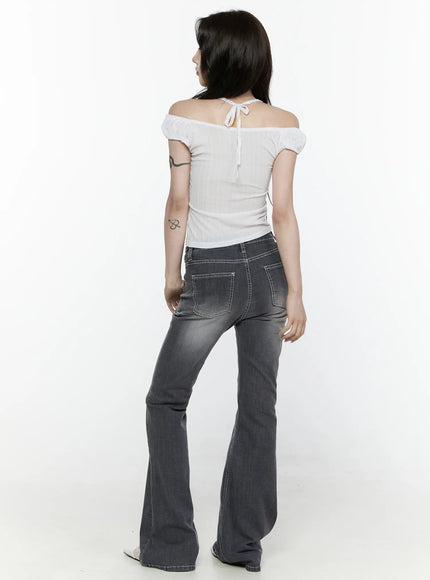 Alira Dark Wash Bootcut Jeans IL522 Gray back shot on model full-body showing rear pockets white contrast stitching bootcut flare and white off-shoulder top with tie detail