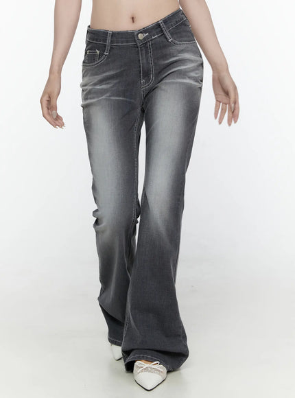 Alira Dark Wash Bootcut Jeans IL522 Gray front shot on model cropped waist to ankle walking pose showing washed grey denim flare leg white contrast stitching and white mules