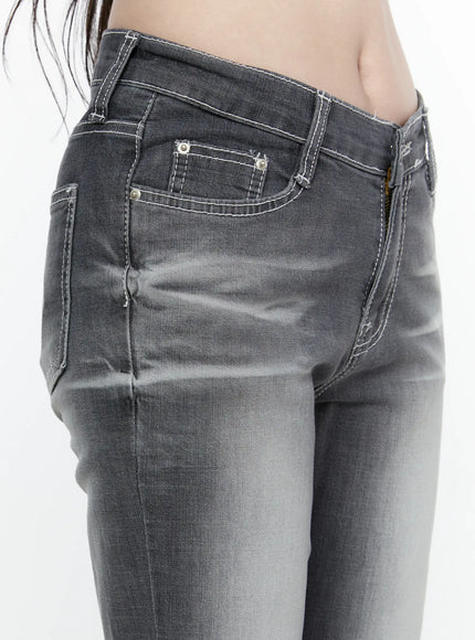 Alira Dark Wash Bootcut Jeans IL522 Gray close-up side detail of hip and pocket area showing silver rivets patch pocket crossover waistband white topstitching and washed denim