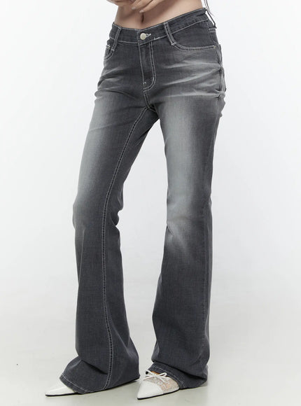 Alira Dark Wash Bootcut Jeans IL522 Gray side shot on model cropped from waist down showing flare leg white contrast stitching and washed denim texture with white mules