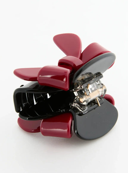 Amber Mix Hair Clip IL503 Black and Red back detail view showing open spring hinge mechanism and red bow tail ends