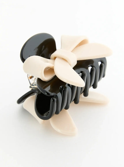 Amber Mix Hair Clip IL503 Black and Ivory side detail view showing open claw mechanism matte cream bow and hinge spring hardware