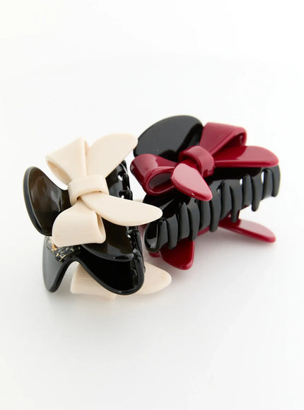 Amber Mix Hair Clip IL503 both color variants flat-lay side-by-side ivory bow and red bow glossy black acrylic claw clips together