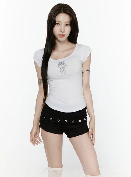 Angel Slim T-Shirt IL522 White front full-length model standing scoop neck slim ribbed cap sleeve tee with silver glitter ANGEL CITY chest graphic paired with black micro shorts