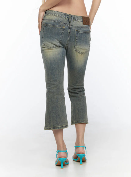 Archie Deep Tint Wash Capri Jeans CL528 Blue back view on model showing rear pockets leather patch label yellow-tinted wash flare hem worn with teal ankle-strap sandals