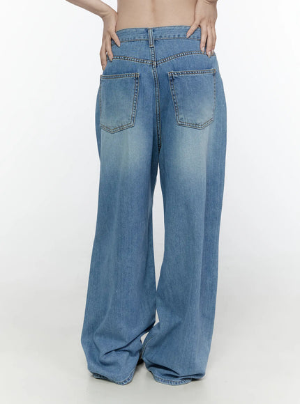Arden Distressed High-Waist Baggy Jeans IL522 Blue back view on model showing double back pockets faded wash and wide-leg hem pooling at floor