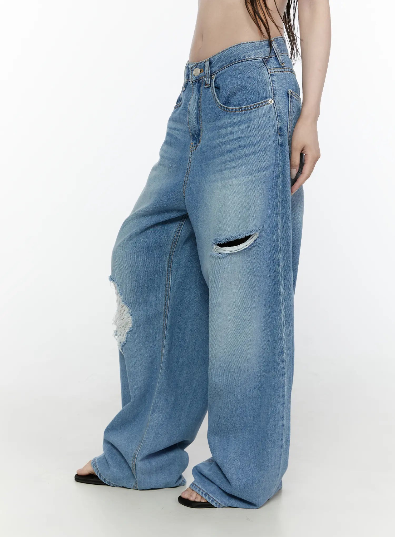 Arden Distressed High-Waist Baggy Jeans IL522 Blue side-view on model showing thigh rip upper knee tear wide-leg silhouette and faded blue denim texture