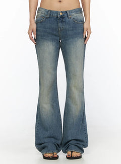 LEWKIN Arian Loose Flared Jeans CL528 Blue front view on model size S showing low-rise waist, vintage wash denim, and wide flared leg hem with sandals