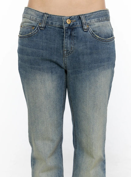 Arian Loose Flared Jeans CL528 Blue close-up detail of low-rise front waistband, brass button, double front pockets, and sun-faded vintage wash denim